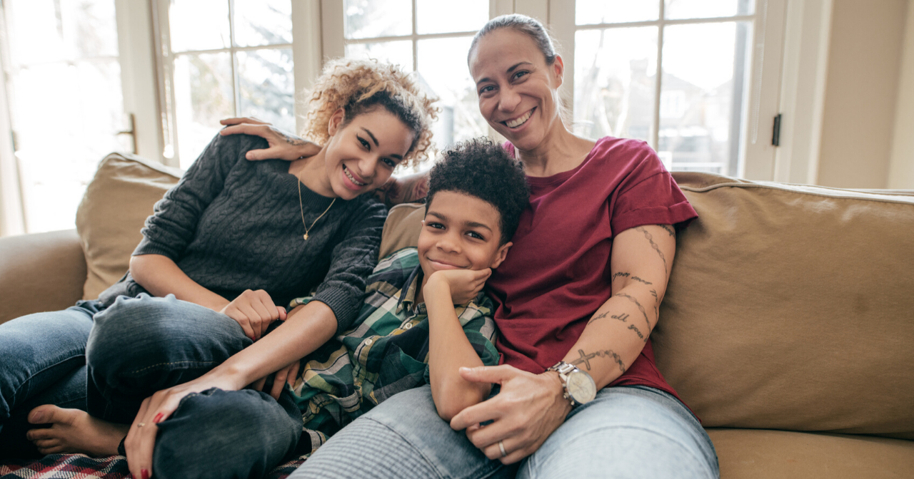 A black mother with her two children, all smiling