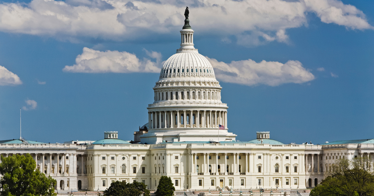 An image of the US Capitol building in the day.