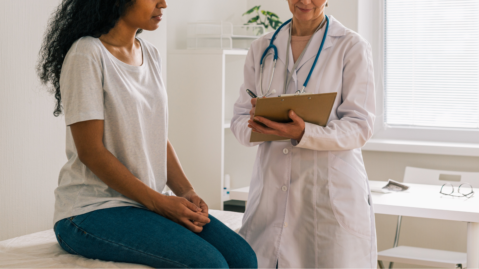Doctor asking patient questions in her office.