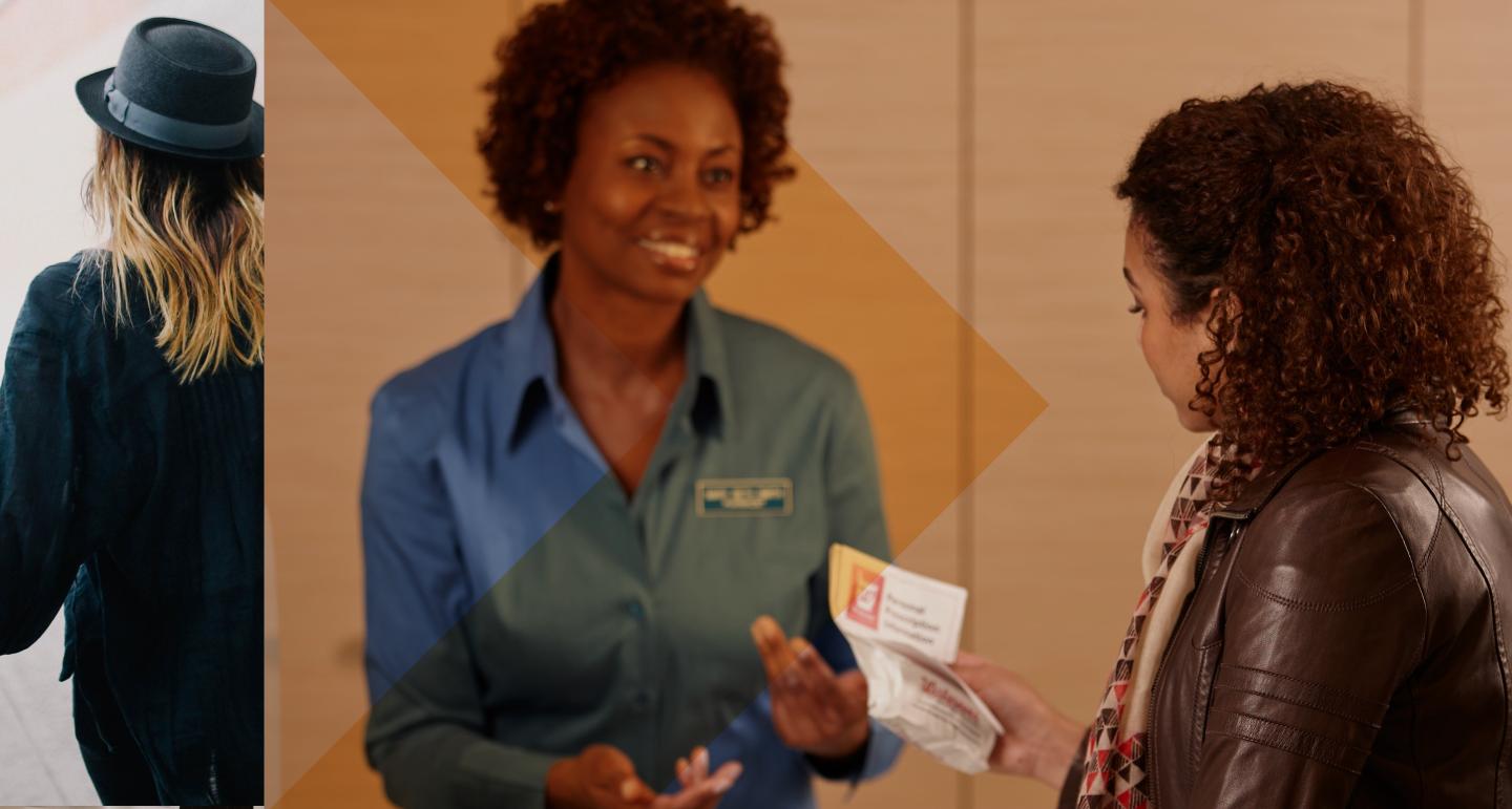 A woman hands another woman a birth control prescription 