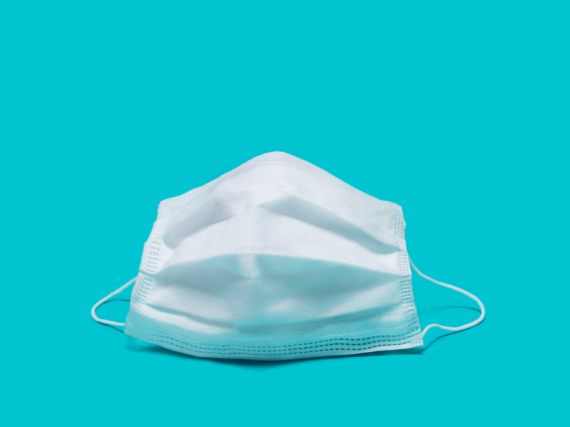 An image of a face mask against a blue background