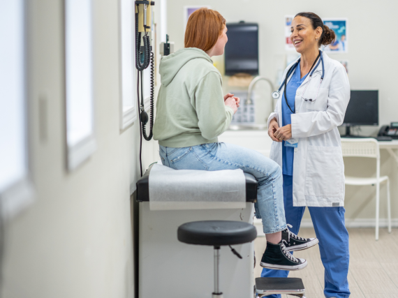Adolescent sitting at a doctor's office talking about birth control.