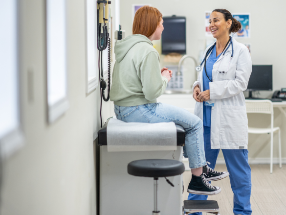 Adolescent sitting at a doctor's office talking about birth control.