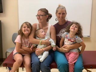 A group photo of Leighton and some of her patients